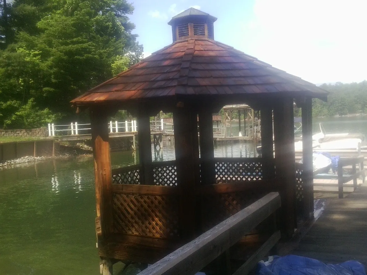 Cedar shake gazebo roof rebuilt on a lake dock in Wenham