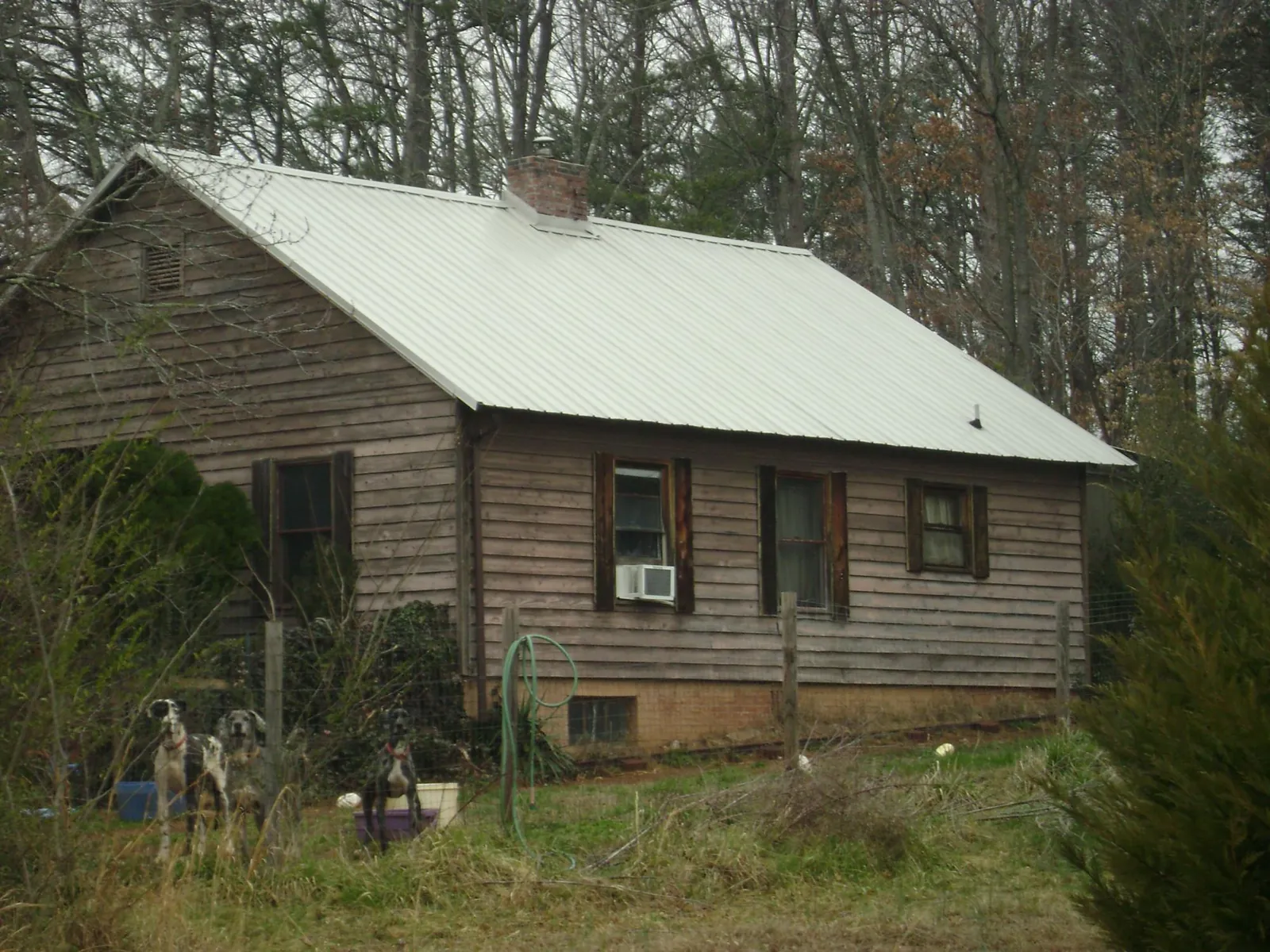 White metal roof on an old wood sided farmhouse, from a Metal Roof Installation job in Wenham